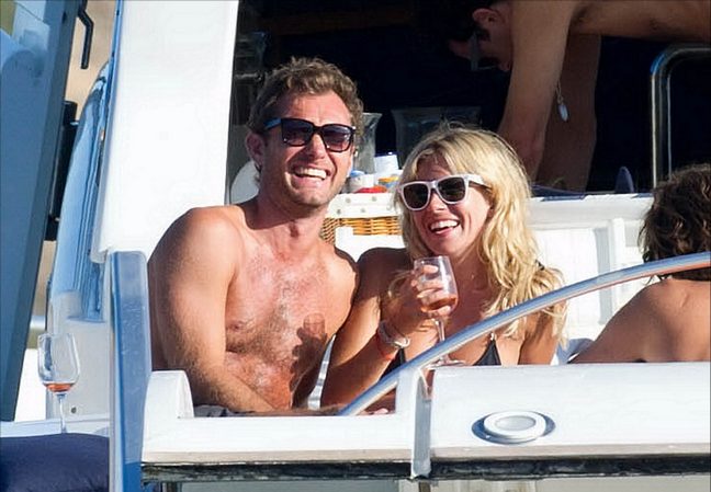 Jude Law, black swim trunks, sunglasses, Sienna Miller, black string bikini, sunglasses, wine glass